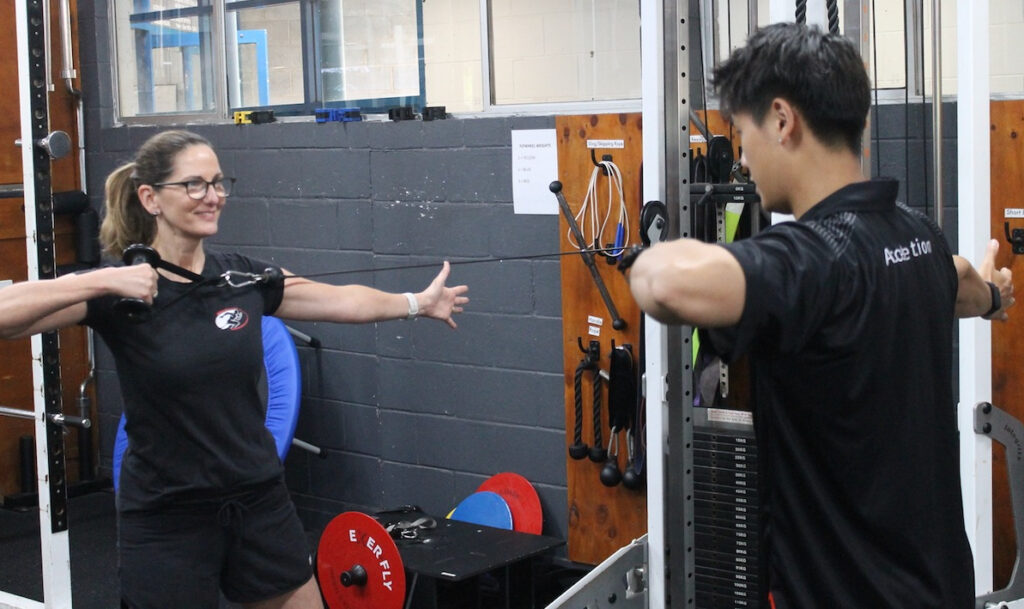 Private fitness coach in Brisbane guiding an individual through a tailored workout session.